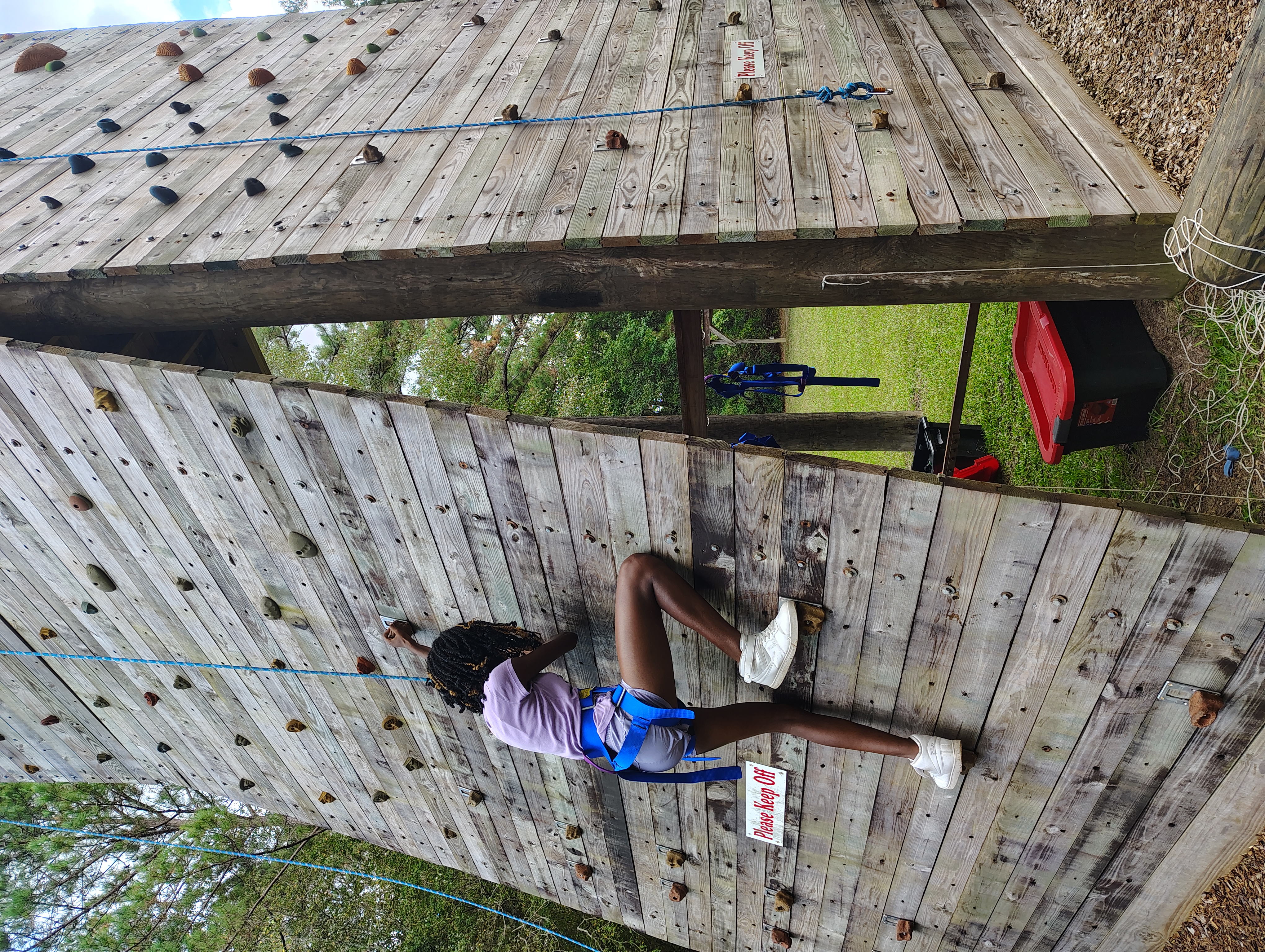Student taking part in the Fall Retreat climbing activity